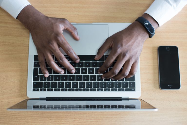 man typing on keyboard